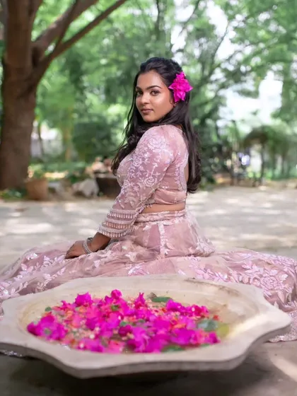 A model posing in a beautiful pink lehenga, perfect for a dreamy and romantic reception look.