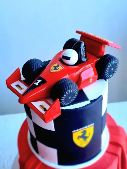 A close-up of the hand-sculpted Ferrari F1 car topper.