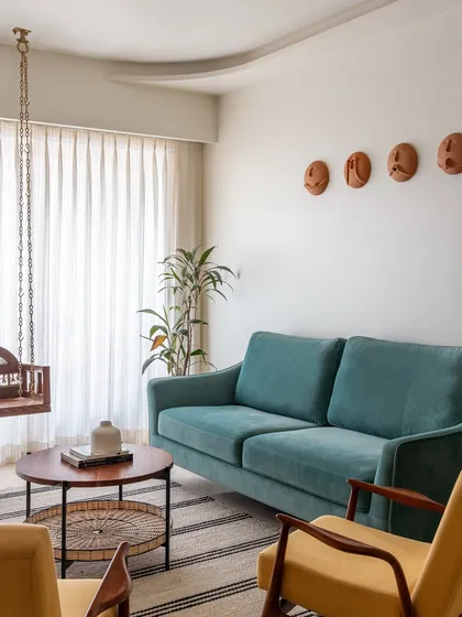 We love incorporating elements that evoke a sense of nostalgia and comfort. A traditional wooden swing, or 'jhoola', becomes a beautiful and functional centerpiece in this living room, blending seamlessly with contemporary furniture for a home that feels both modern and rooted.