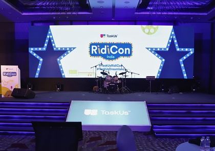 The main stage for 'RidiCon India,' a corporate conference. The design incorporates the brand's star logo and colors, with a professional setup for a live band and presentations.