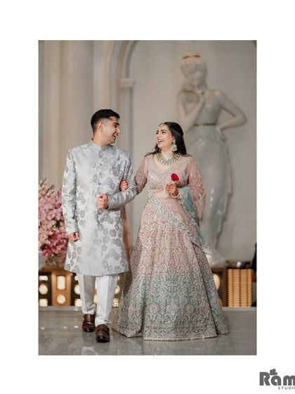A happy, candid shot of the couple walking arm-in-arm through a grand hall, sharing a smile. This image captures their joy and easy chemistry.