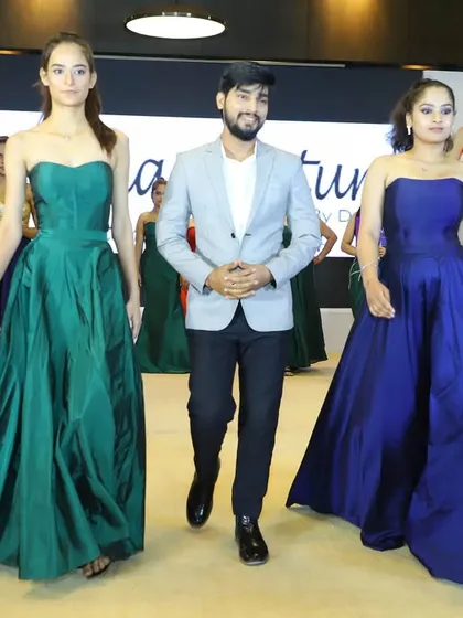 A proud moment for me on the runway at the Celebrity Business Awards. My collection of custom gowns, including these jewel-toned green and blue pieces, was showcased on the ramp. It’s always amazing to see my designs come to life.