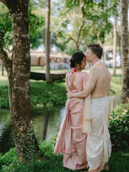 A loving embrace in a lush, green garden. Bhavana and Michael's connection is beautifully framed by nature in this serene portrait from their traditional wedding day.