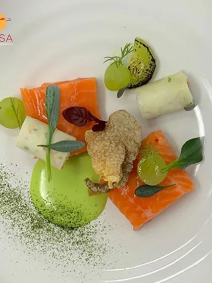This is where culinary art meets corporate dining. A beautifully plated dish of cured salmon with avocado puree and fresh greens, showcasing the fine-dining experience we can create for your special events.