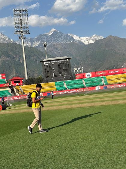 God's gift to cricketers. The shadow falls long on the perfect green outfield of the Dharamsala stadium, with the Himalayas in the background.