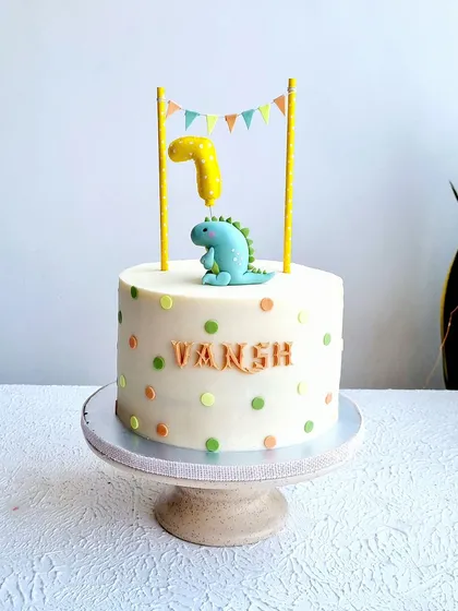 A full view of the simple polka dot dinosaur cake.
