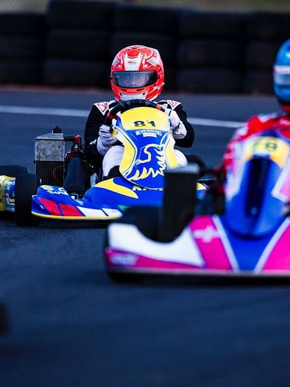 A close-up shot of two karts battling for position on the track.