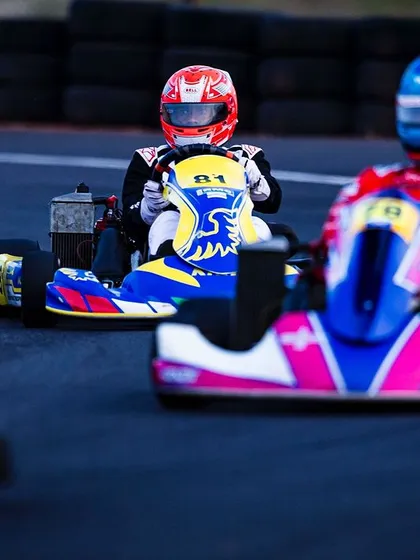 A close-up shot of two karts battling for position on the track.