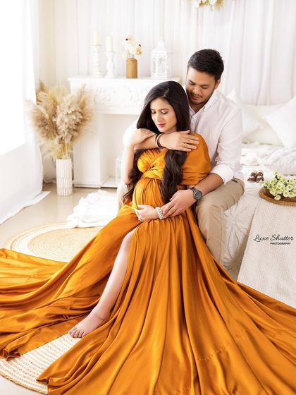 A tender moment in our bright, boho-inspired bedroom set. The husband's embrace from behind is a classic pose that feels both supportive and romantic.