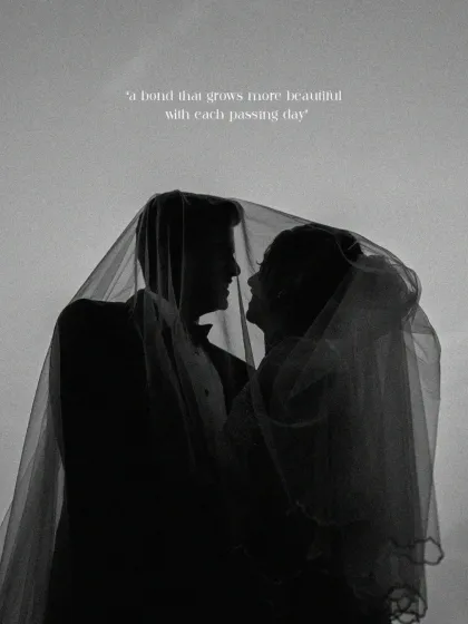 An intimate silhouette of the bride and groom beneath a delicate veil. This fine-art portrait captures the quiet promise and deep connection between two souls, a bond that grows more beautiful with each passing day.