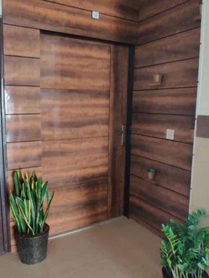 The "before" shot of the entrance, showing a plain door and wall. This provides a stark contrast to the beautifully designed final result.