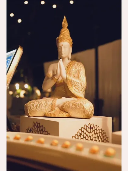 A serene Buddha statue as part of the decor for a Pan-Asian themed food station, helping to create an immersive culinary atmosphere.