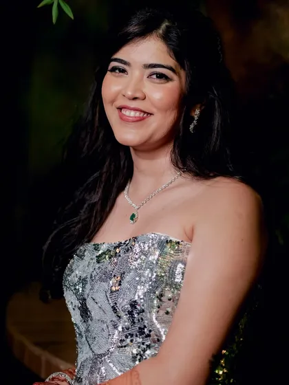 A smiling shot of Reeya at her cocktail party. Her snatched and sharp makeup look exudes confidence and glamour.
