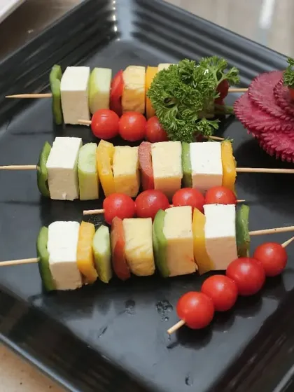 Fresh and healthy, these paneer and vegetable skewers are a great light starter. We thread cubes of paneer with colorful bell peppers, cucumber, and cherry tomatoes for a refreshing and vibrant appetizer.