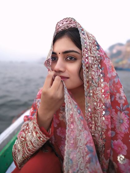 A glance through a veil of tradition. This intimate portrait on the Ganga captures the subject's soulful eyes and the delicate beauty of her ethnic wear.