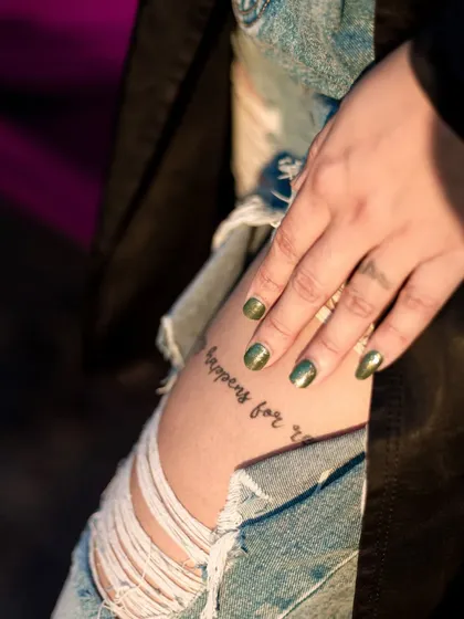 A detailed shot focusing on a tattoo and nail art. These close-ups are great for showing different aspects of a model's look or for accessory brands.