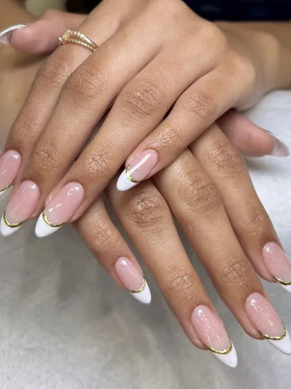 You can never go wrong with a classic French manicure, but I love adding a little twist. This elegant look features a delicate gold chrome line along the tip for a modern and sophisticated finish on these almond-shaped nail extensions.