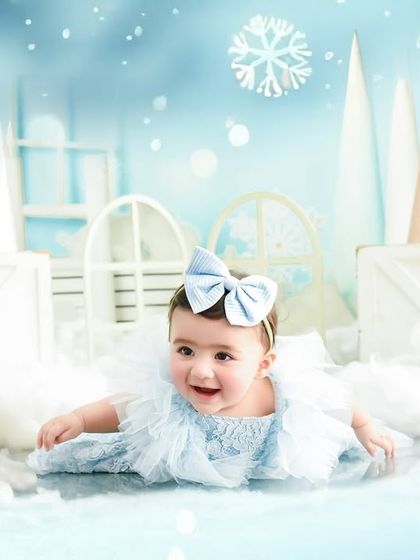 A happy tummy-time moment in a magical snowy landscape. Sitter sessions are perfect for capturing those first push-ups and big smiles.