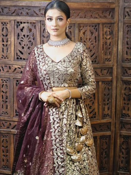 A unique bronze and maroon lehenga with a modern, geometric pattern. This is a great choice for a reception or sangeet look.