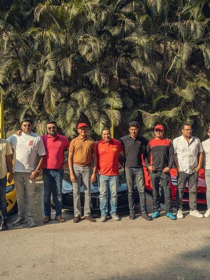 A group photo with the passionate owners and their cars at the Ferrari Weekender. These events are about community, and I love bringing people together through music.