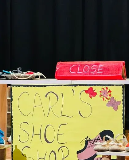 The simple, child-made set for 'Carl's Shoe Shop' in our production of 'The Elves and the Shoemaker'. We encourage children to be involved in all aspects of the production.