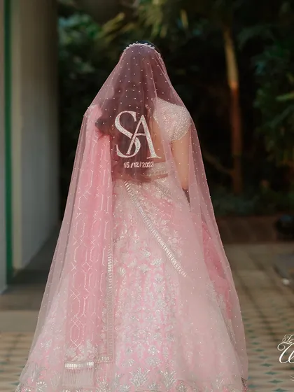 A personalized veil is a beautiful modern touch. This bride's veil was customized with the couple's initials and wedding date, adding a unique and sentimental detail to her look.