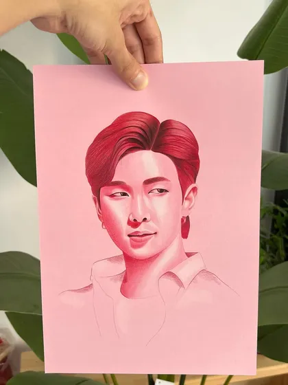 This is Kim Namjoon (RM) from BTS, created with colored pencils on pink paper. This series is a wonderful exercise in understanding value and tone.