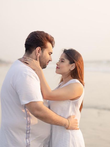 A soft and romantic close-up of the couple on a beach in Goa, capturing the warm glow of the setting sun.