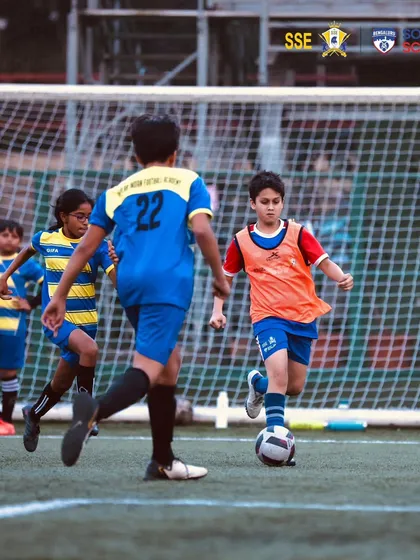 A young player on the dribble during a match at the Cooperage Stadium.