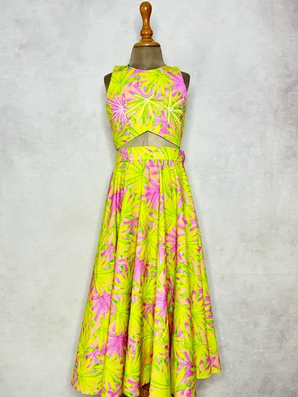 A closer look at our Neon Leaves Lehenga. The vibrant print on thick cotton is accented with subtle embroidery, making it a comfortable yet standout choice for festive occasions.