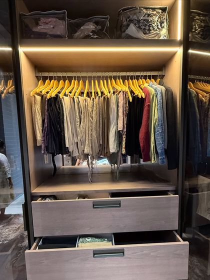 This shot highlights the use of top-shelf storage for seasonal items in clear-front bags, keeping them dust-free but still identifiable.