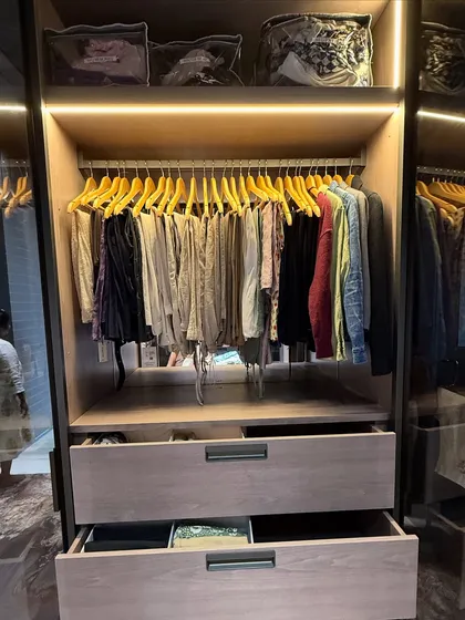 This shot highlights the use of top-shelf storage for seasonal items in clear-front bags, keeping them dust-free but still identifiable.