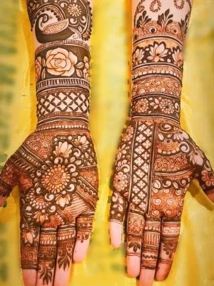 A showcase of our heavy, intricate mehndi work, perfect for a bride. This design features a mix of peacock motifs, roses, and detailed patterns covering the full hands and wrists.