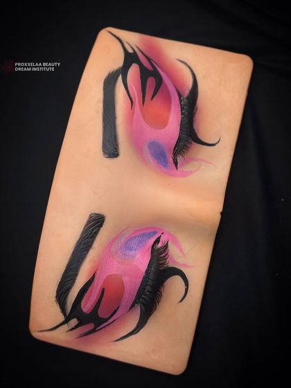 Another angle of the dramatic graphic liner practice, demonstrating the creativity and control required for advanced eye makeup.