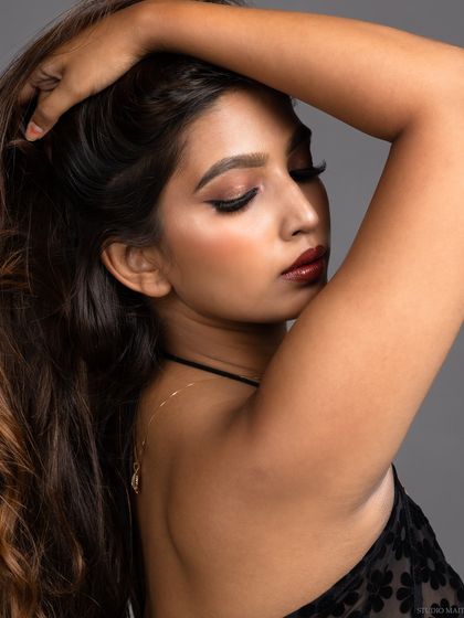 A close-up beauty shot from the side, highlighting the model's features and hair.