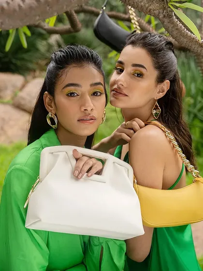 A fashion-forward shot from the Sarjaa campaign, with models showcasing bold makeup and accessories. The focus is on creating a strong, cohesive brand image.