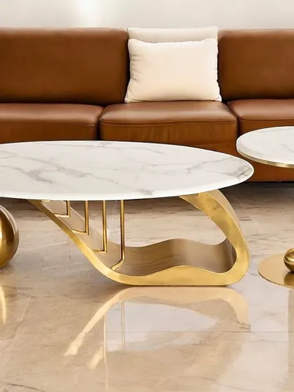 The Golden Mesa coffee table and matching side table are the embodiment of robust elegance. The design features a unique spherical element within the PVD-coated stainless steel base, making it a standout piece of modern furniture.
