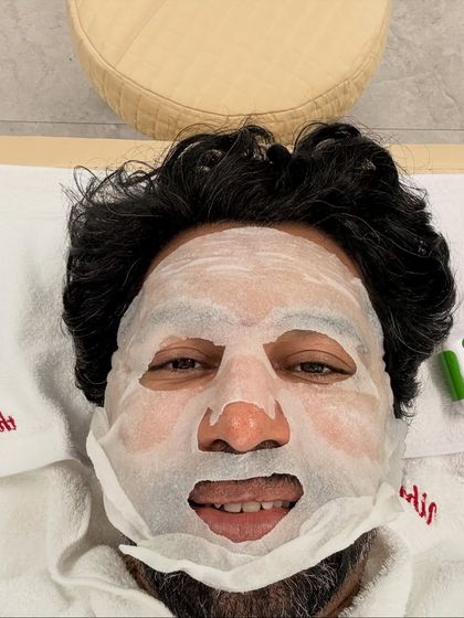 Trying out an anti-aging sheet mask during my facial treatment in Seoul. It's a fun way to experience the culture of skincare innovation.