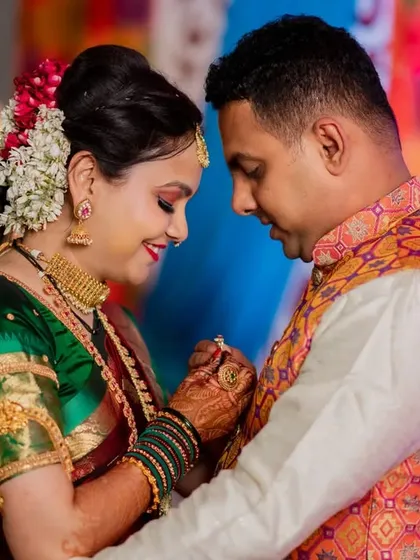 A tender moment between Swapnil and Ankita during their engagement. The focus on their hands and the ring tells a story of commitment.
