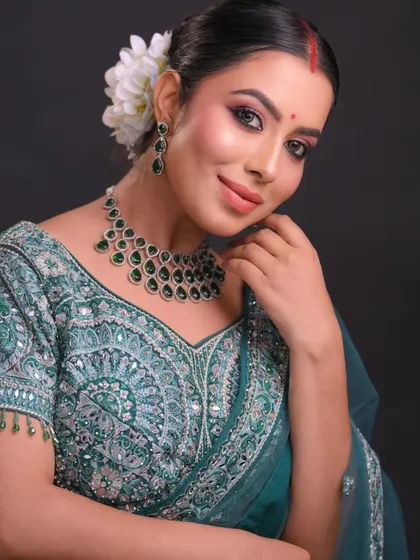 Another pose from the same set, showing the intricate embroidery on the blouse and how the makeup complements it.