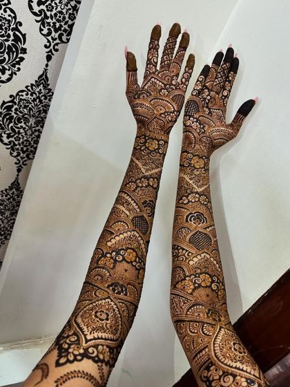 A shot of both arms, showing the symmetry and the beautiful back-of-hand design.