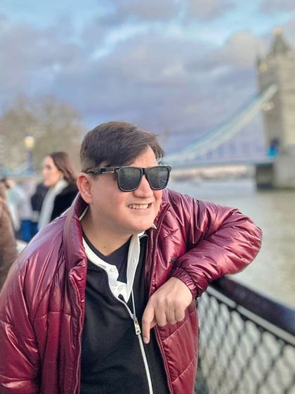 A candid moment in a different outfit, a burgundy puffer jacket, showing versatile winter style in London.