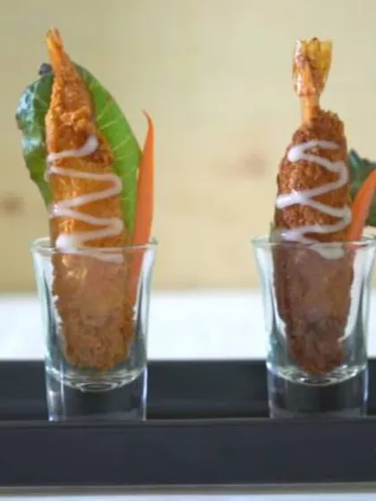 Crusted Prawns served in shot glasses. This elegant presentation makes for a sophisticated seafood appetizer, combining crispy texture with succulent prawns.