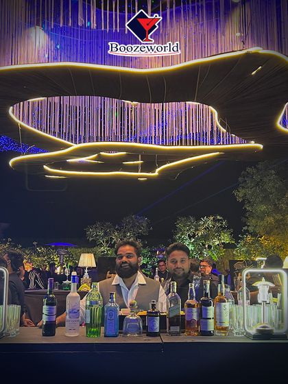 Our dream team, posing behind a beautifully lit bar at a large-scale event. We work together seamlessly to manage high-volume service while maintaining a fun atmosphere.