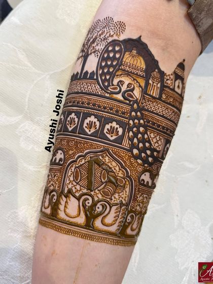 The completed armband, with the peacock and palace scene fully detailed, and additional elements like elephants and swans below it.