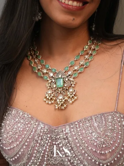 Jewellery for your bride tribe is just as important. This timeless Victorian-style necklace, with its delicate emerald-like stones and uncut polki look, is a piece I designed for the sister of the bride or a bridesmaid.