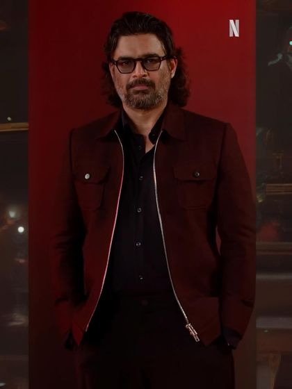 A full look of R. Madhavan styled for 'Shaitaan'. The deep burgundy jacket with clean lines and a modern zip-front creates a sharp, contemporary silhouette that is both stylish and intimidating.