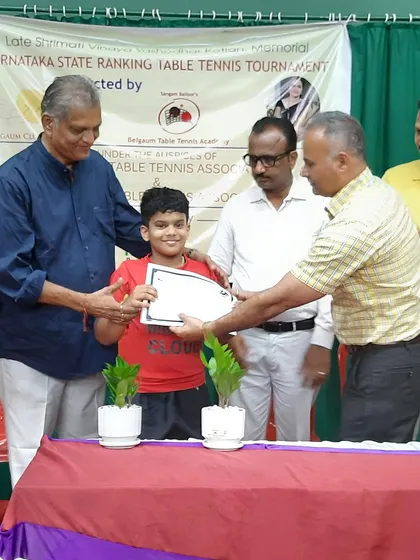 One of our young champions is awarded his certificate at the state ranking tournament. His smile reflects the joy of achievement that comes from disciplined practice and competitive play.