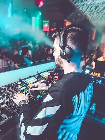 A dynamic shot from the DJ booth with smoke and blue lights, capturing the intensity of a peak-hour set. My focus is on reading the crowd and delivering the right beat at the right time.