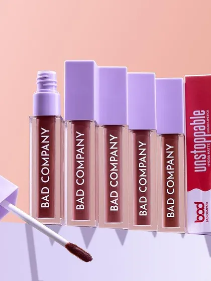 A hero shot of liquid lipsticks stacked in a neat, ascending line. We used geometric blocks and a soft, two-tone background to create a visually pleasing composition that highlights the product packaging.